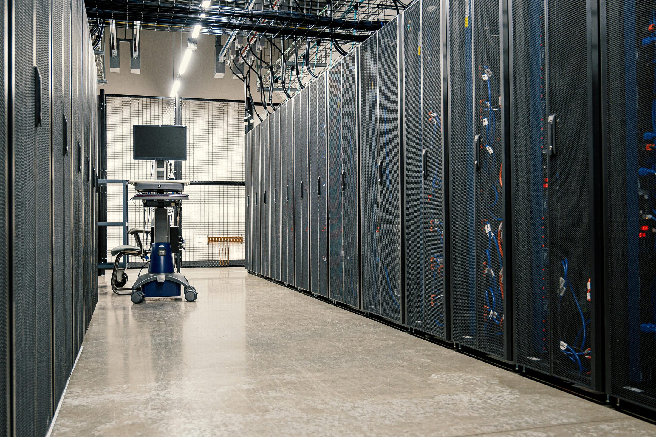 Data center corridor lined with server racks